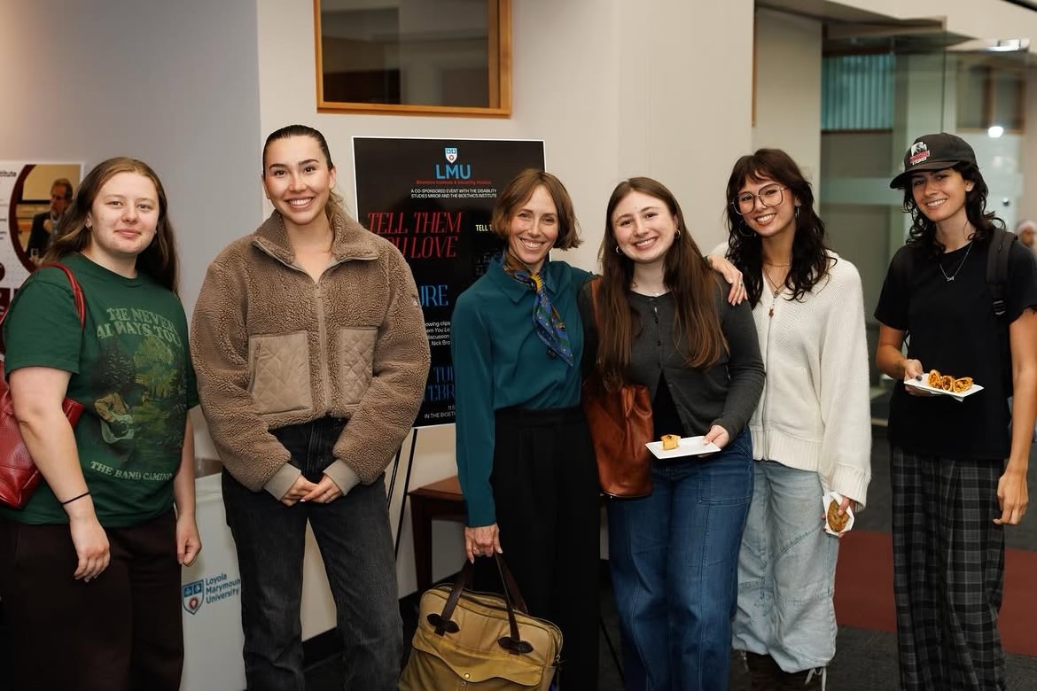 Amanda Apgar and students posed in front of lecture poster